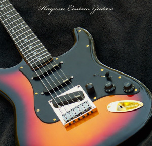 Image-Haywire Custom Guitars Sunburst Stratocaster with EMG pickups and a Telecaster bridge.